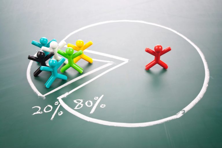 a group of colorful plastic people on a chalkboard